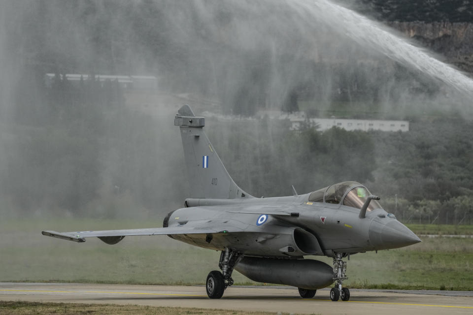 A Rafale jets is sprayed with water as the Greek air force salutes six new jets at Tanagra military air base, about 82 kilometres (51miles) north of Athens, Greece, on Wednesday, Jan. 19, 2022. Six advanced-tech Rafale jets bought from the French air force were handed over Wednesday to the Greek armed forces ‒ the first major delivery to result from multi-billion euro defense deals sealed with Paris last year. (AP Photo/Thanassis Stavrakis)