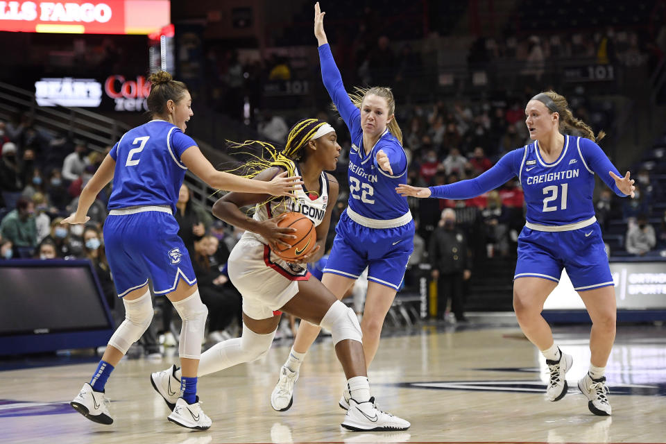 Connecticut's Aaliyah Edwards (3) is pressured by Creighton's Tatum Rembao (2), Carly Bachelor (22) and Molly Mogensen (21) in the second half of an NCAA college basketball game, Sunday, Jan. 9, 2022, in Storrs, Conn. (AP Photo/Jessica Hill)