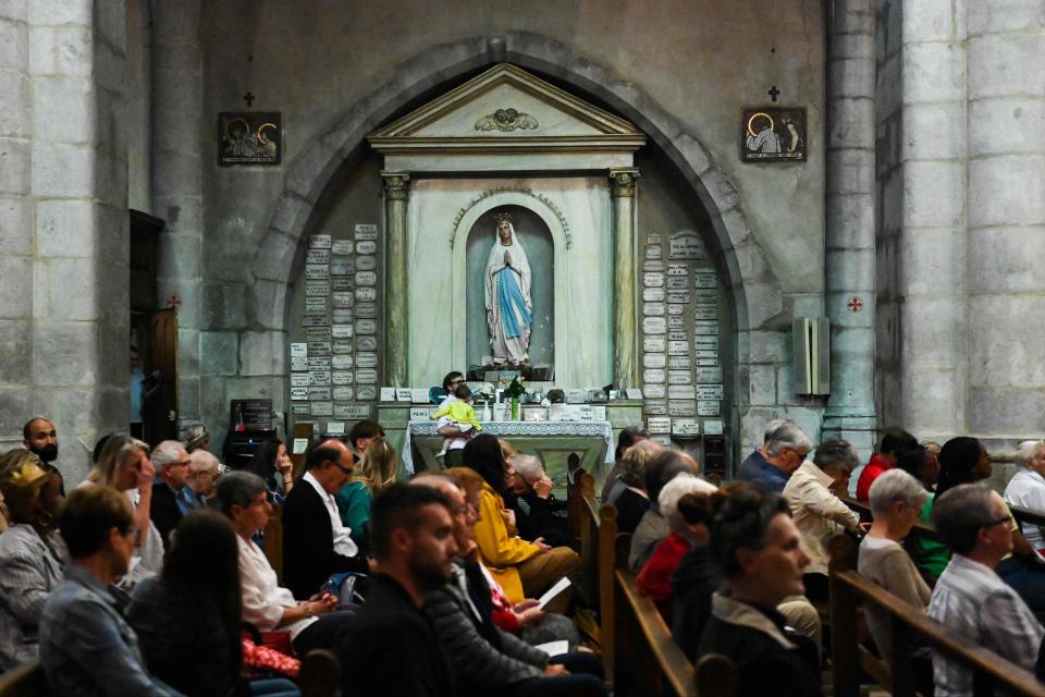 Locals take part in a mass on Friday, the day after the ‘savage’ knife attack (AFP via Getty Images)