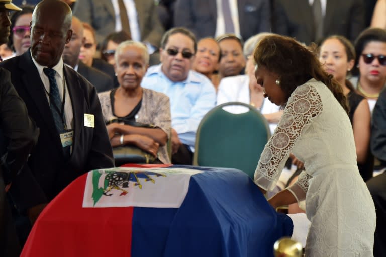 Elisabeth Preval, widow of former President Rene Preval, stands by his casket at the Haitian National Pantheon Museum, in Port-au-Prince, on March 10, 2017