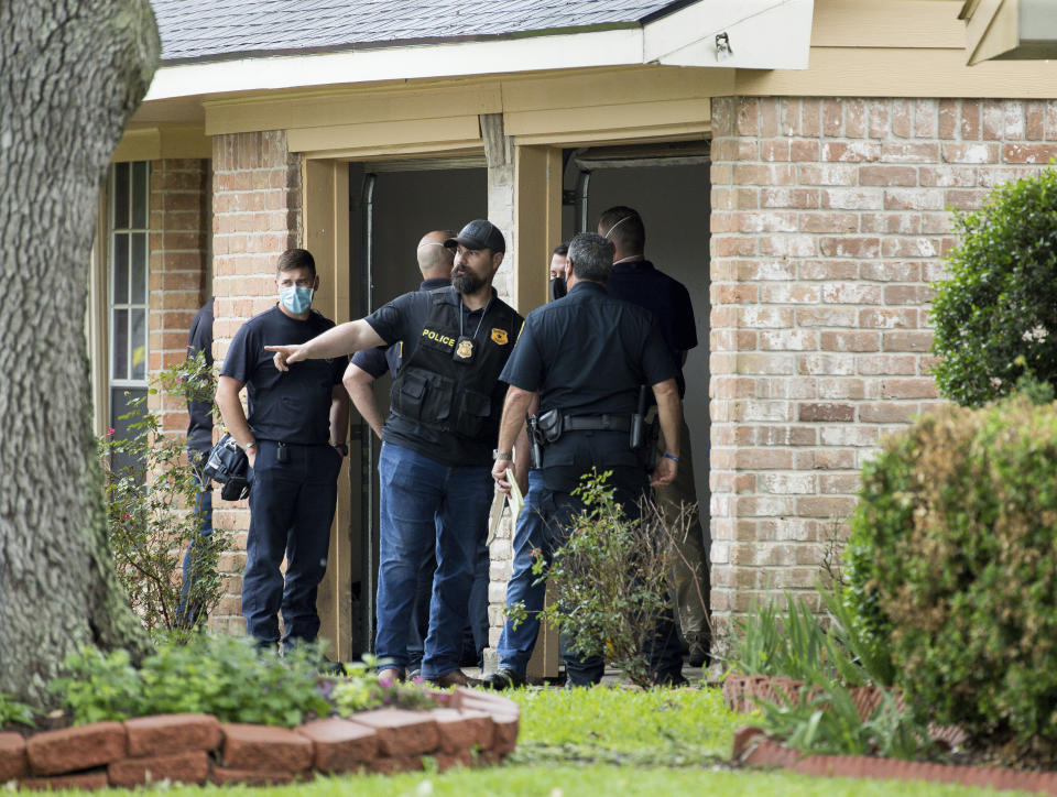 Law enforcement officials investigate the site of a human smuggling case, where more than 90 undocumented immigrants were found inside a home on the 12200 block of Chessington Drive on Friday, April 30, 2021, in Houston. A Houston Police officials said the case will be handled by federal authorities. ( Godofredo A. Vásquez/Houston Chronicle via AP)