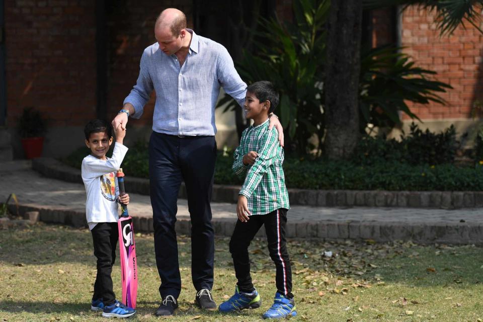 The Duke of Cambridge meets young children while playing cricket (PA)