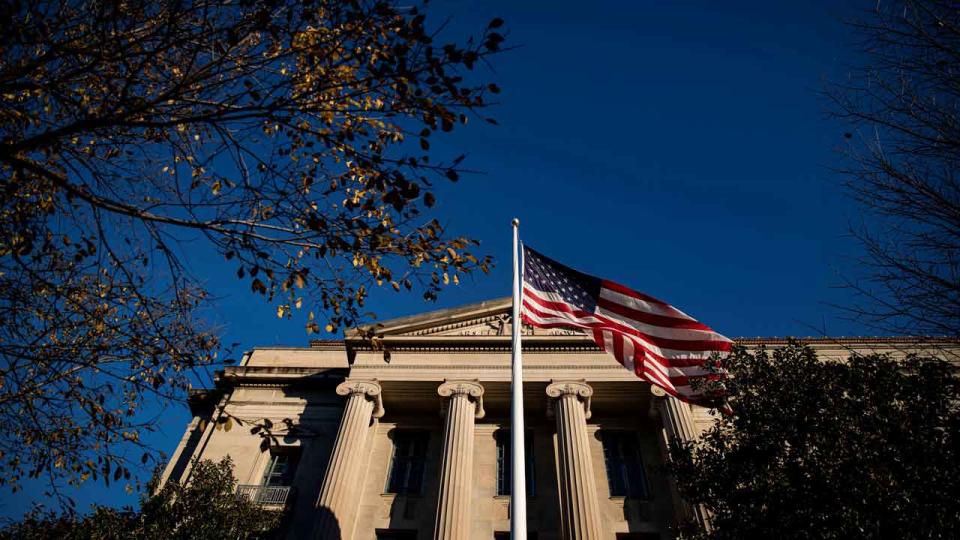 Justice Department building with US flag in front