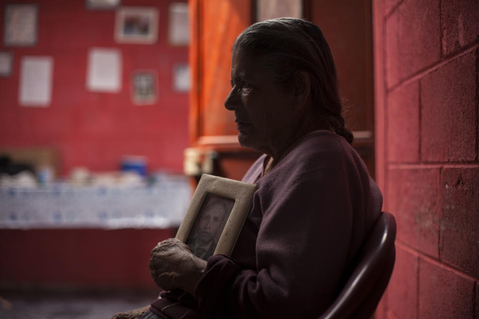 In this March 6, 2014 photo, Austina Machic, 76 years-old, holds a portrait of her late husband Horacio Tajtaj Callejas during an interview at her home in San Andres Itzapa, Guatemala. In November 1988 in the mountainous area of western Guatemala, 22 men who lived in the village of El Aguacate where massacred by leftists guerillas during the Guatemalan civil war. The case will be taken to court on Thursday March 13, 2014 in which more than 30 persons are expected to testify. Horacio Tajtaj Callejas was killed in the massacre. (AP Photo/Luis Soto)