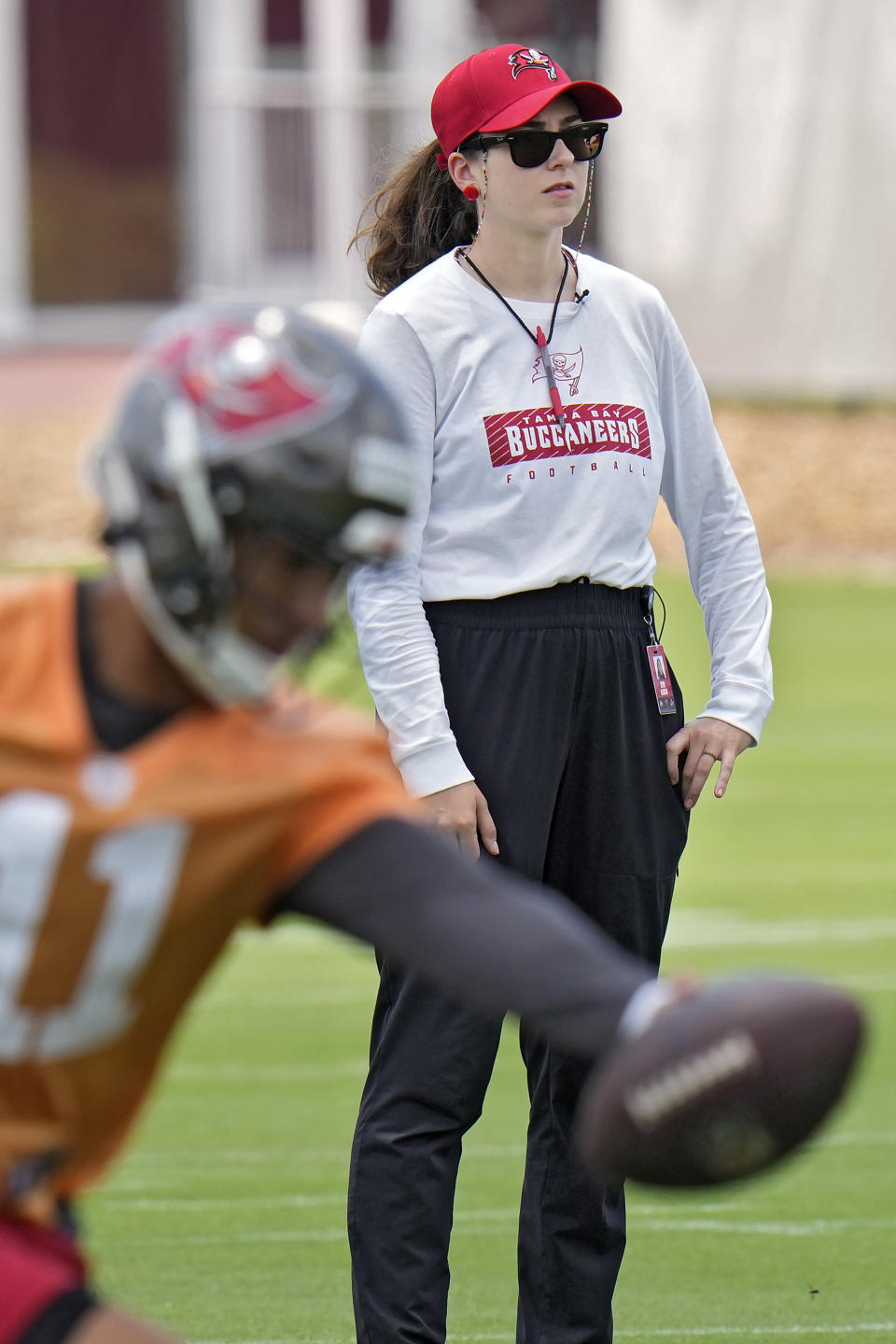 Ester Alencar, quarterbacks coach of the Rio Preto Weilers in Brazil, watches Tampa Bay Buccaneers quarterbacks at the NFL football team's rookie training camp, Friday, May 10, 2024, in Tampa, Fla. Twenty-five aspiring NFL coaches, with wide-ranging backgrounds, joined together at the inaugural Tampa Bay Buccaneers National Coaching Academy. (AP Photo/Chris O'Meara)