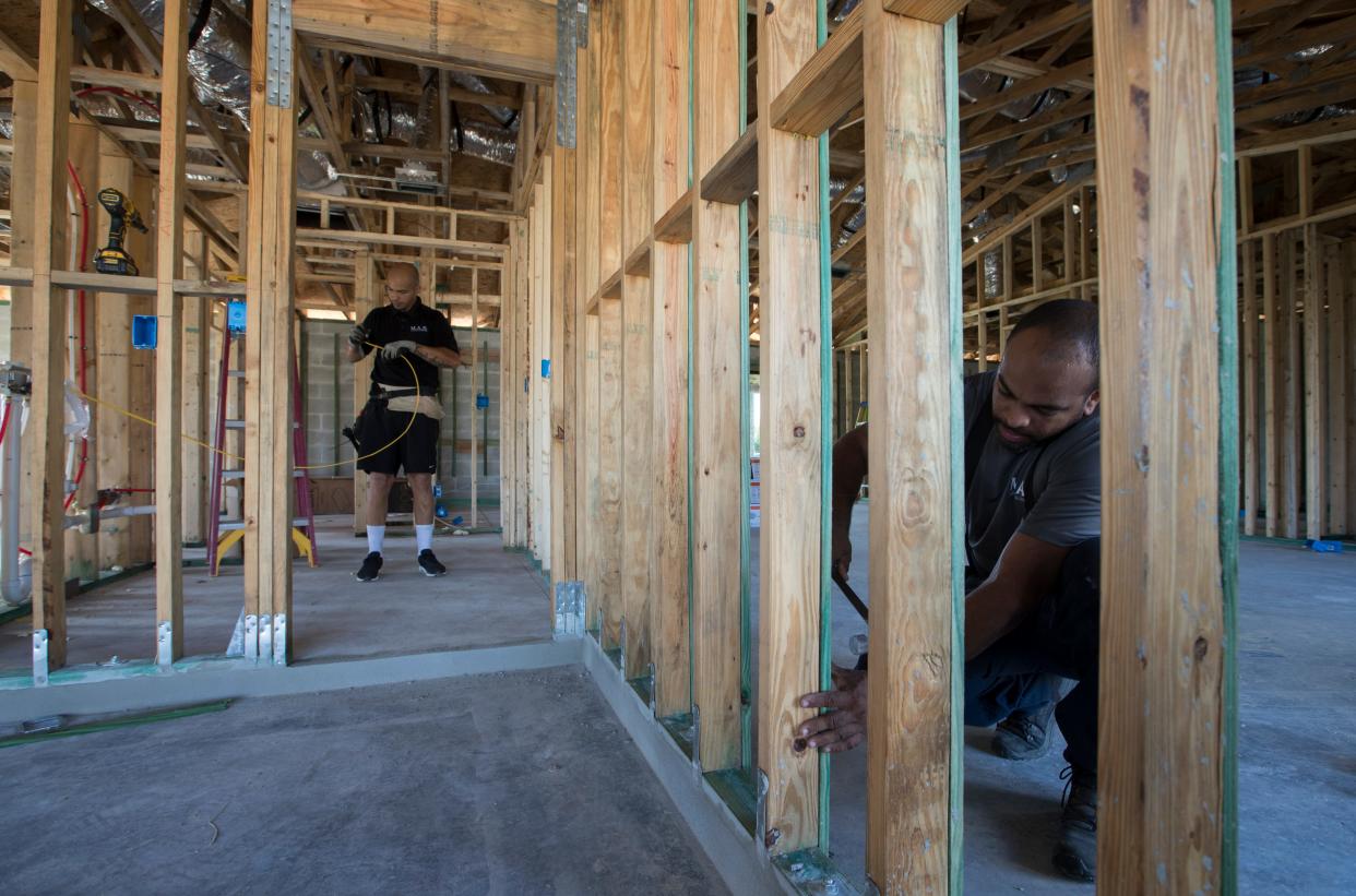 Workers install electrical lines and framing structures to a new home being built in Cape Coral last year. Cape Coral has steadily increased the number of new construction permits it's approved in the past several years, as it works back up to pre-recession numbers.