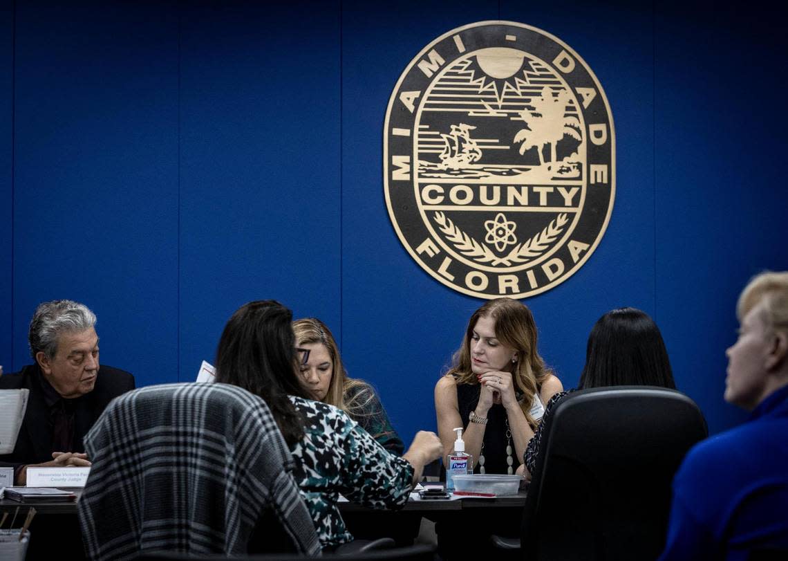 The Miami-Dade County Canvassing Board, from left to right: Judge Luis Perez Medina, Judge Victoria Ferrer and Miami-Dade County Supervisor of Elections Christina White examine signatures on Oct. 20, 2022.