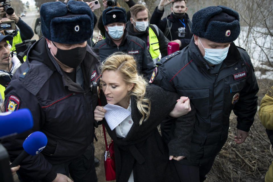 Police officer detain the Alliance of Doctors union's leader Anastasia Vasilyeva at the prison colony IK-2, which stands out among Russian penitentiary facilities for its particularly strict regime, in Pokrov in the Vladimir region, 85 kilometers (53 miles) east of Moscow, Russia, Tuesday, April 6, 2021. Doctors from the Navalny-backed Alliance of Doctors announced going to the Pokrov prison on Tuesday to demand the opposition leader gets qualified medical help from independent doctors after he complained about pain in his leg and back. (AP Photo/Pavel Golovkin)