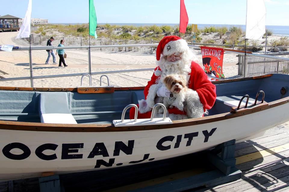 Santa holds a dog in Ocean City, New Jersey, on Oct. 22.