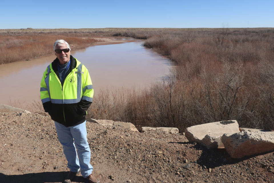 John Osgood, the public works director for Navajo County, talks about a levee project at the Little Colorado River in Winslow, Arizona, on Feb. 4, 2022. The U.S. Army Corps of Engineers recently announced a flood control project in the city would receive $65 million in funding. (AP Photo/Felicia Fonseca)