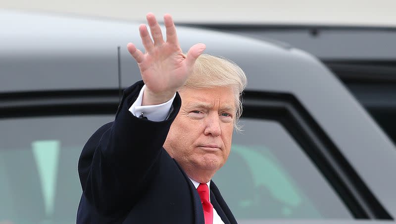 President Donald Trump waves to the crowd at Roland R. Wright Air National Guard Base at the Salt Lake City International Airport in Salt Lake City on Dec. 4, 2017.