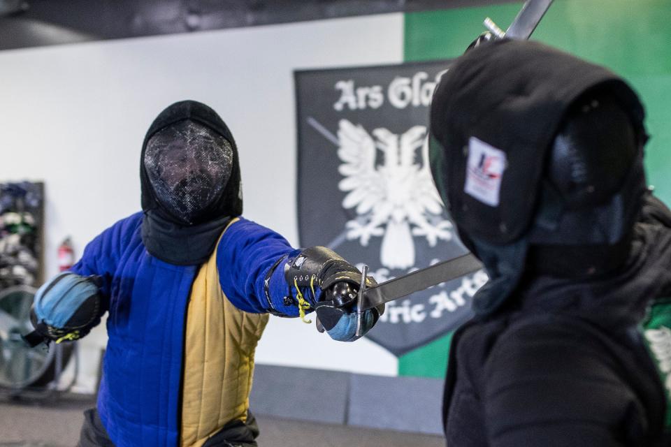 Jacob Pigeon, left, and Katharine Keller demonstrate a saber fight at Ars Gladii School of Chivalric Arts in Garden City on Saturday, April 29, 2023.