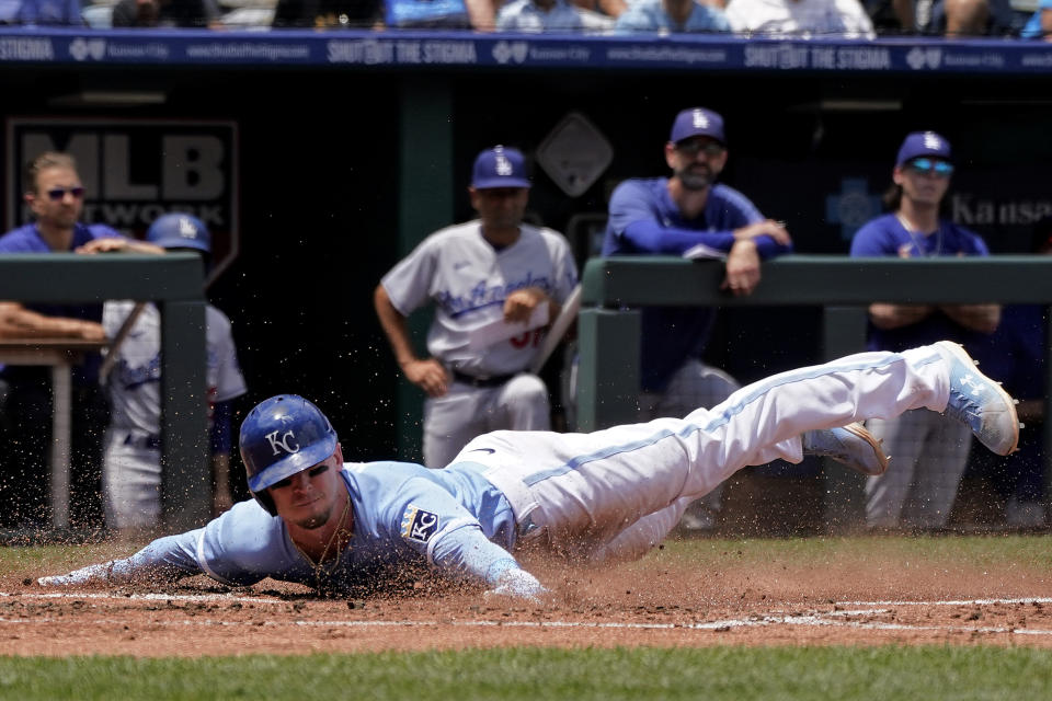 Kansas City Royals' Drew Waters slides home to score on a single by Maikel Garcia during the second inning of a baseball game against the Los Angeles Dodgers Sunday, July 2, 2023, in Kansas City, Mo. (AP Photo/Charlie Riedel)