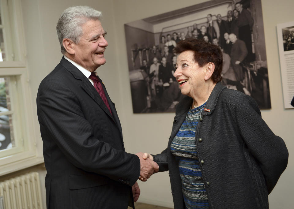 FILE - German President Joachim Gauck welcomes Holocaust survivor Inge Deutschkron, chairwoman of the Blind Trust Association, to the Otto Weidt Workshop for the Blind in Berlin, Germany, Nov. 8, 2013. The Holocaust survivor has died at the age of 99. This was confirmed by the Schwarzkopf Foundation Young Europe on Wednesday, citing her personal environment. (Britta Pedersen/dpa via AP)