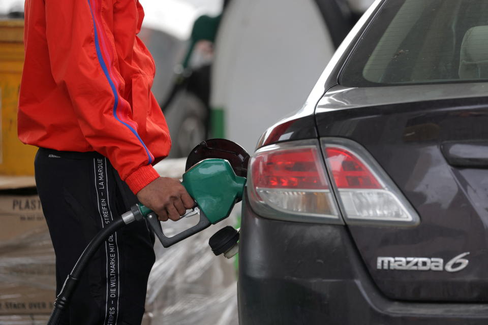 A person uses a petrol pump at a gas station as fuel prices surged in Manhattan, New York City, U.S., March 7, 2022. REUTERS/Andrew Kelly