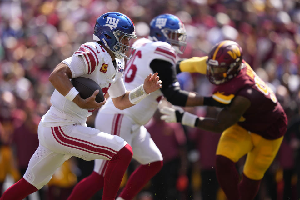 New York Giants quarterback Daniel Jones (8) runs against the Washington Commanders during the first half of an NFL football game in Landover, Md., Sunday, Sept. 15, 2024. (AP Photo/Matt Slocum)