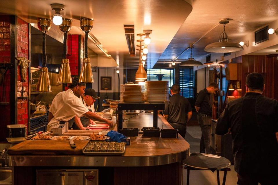 The kitchen staff prepares meals on a recent day at the Golden Ox, which serves organically fed beef dry-aged 14 to 21 days.