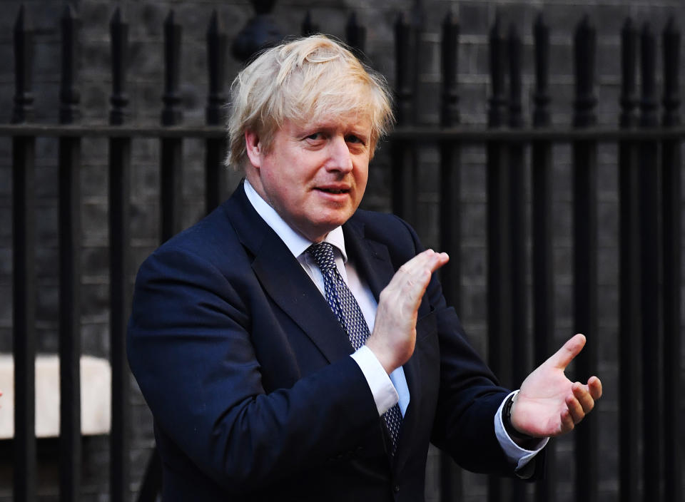 LONDON, ENGLAND - MAY 14:  Prime Minister Boris Johnson applauds for key workers outside 10 Downing Street on May 14, 2020 in London, England. Following the success of the "Clap for Our Carers" campaign, members of the public are being encouraged to applaud NHS staff and other key workers from their homes at 8pm every Thursday. The Coronavirus (COVID-19) pandemic has infected over 4 million people across the world, claiming at least  33,614 lives in the U.K. (Photo by Leon Neal/Getty Images)