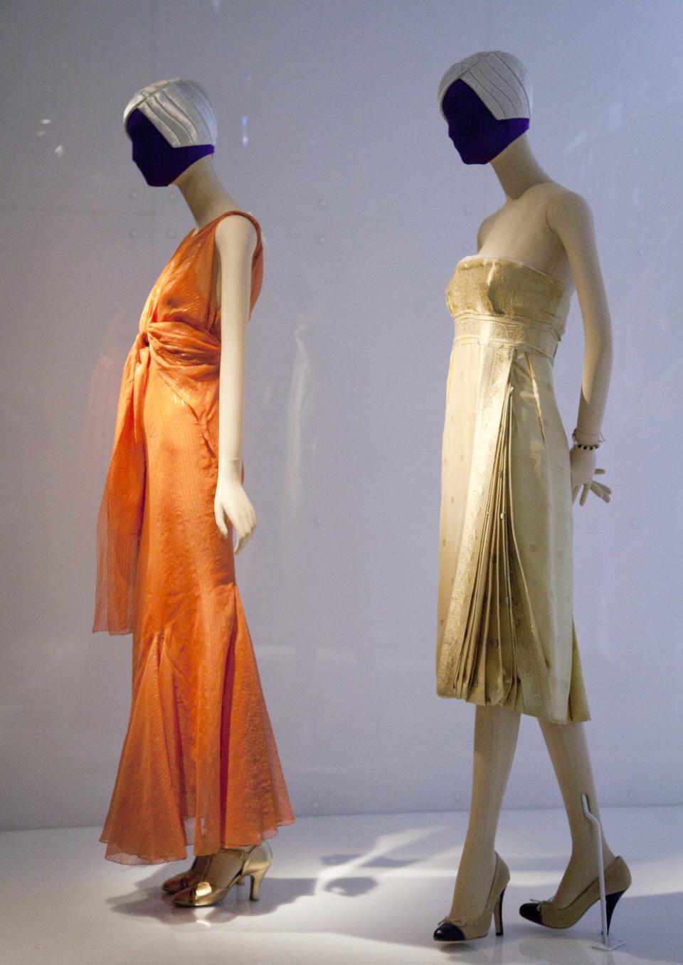 A 1935 evening dress, left, by Elsa Schiaparelli, and a 2004 dress by Miuccia Prada are are on display at the Metropolitan Museum of Art, Monday, May 7, 2012 in New York. The show "Schiaparelli and Prada, Impossible Conversations," opens May 10 and continues through Aug. 19. (AP Photo/Mark Lennihan)