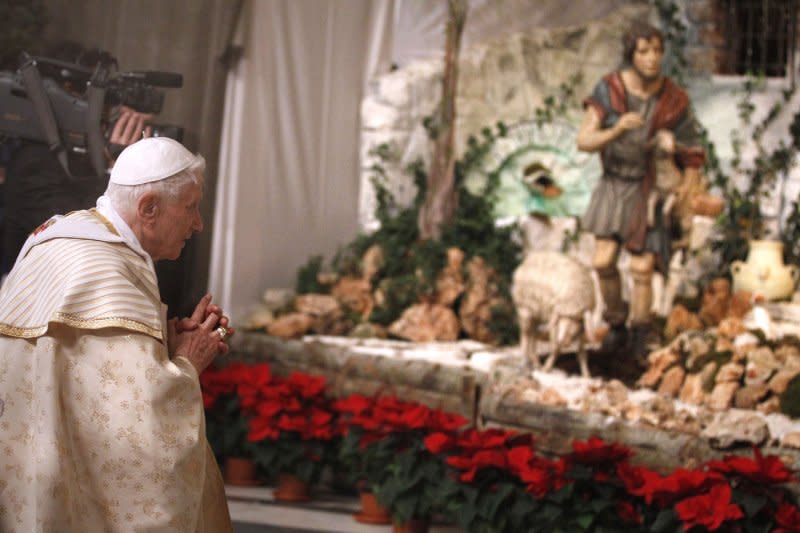 Pope Benedict XVI prays at the nativity scene after celebrating Christmas Eve Mass in St. Peter's Basilica at the Vatican on December 24, 2012. On December 25, 2007, the pope revealed a new-style nativity scene in the Vatican's St. Peter's Square. It depicted Jesus' birth in Joseph's house, with no mention of a manger or journey to Bethlehem. File Photo by Stefano Spazani/UPI