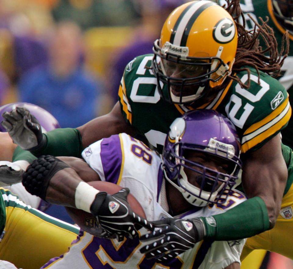 Green Bay Packers safety Atari Bigby stops Minnesota Vikings running back Adrian Peterson short of a first down during the first quarter of their game Sunday, November 10, 2007 at Lambeau Field in Green Bay, Wis.