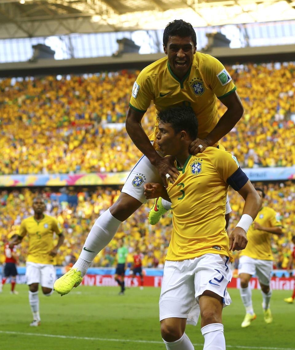 Brazil's Thiago Silva (3) celebrates with Paulinho after scoring a goal during the 2014 World Cup quarter-finals between Brazil and Colombia at the Castelao arena in Fortaleza July 4, 2014. REUTERS/Marcelo Del Pozo