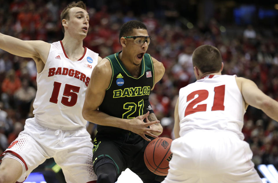 Baylor center Isaiah Austin (21) is pressured by Wisconsin's Sam Dekker (15) and Josh Gasser (21) during the second half of an NCAA men's college basketball tournament regional semifinal, Thursday, March 27, 2014, in Anaheim, Calif. (AP Photo/Jae C. Hong)