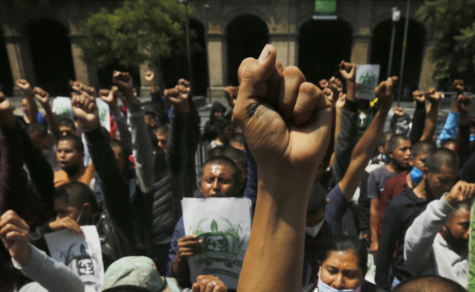 Students, joined by relatives of the 43 missing students from the Rural Normal School of Ayotzinapa, chant outside the Supreme Court during a protest to mark the upcoming sixth anniversary of the students' disappearance, in Mexico City, Wednesday, Sept. 23, 2020. Family members continue to call for justice six years after the Ayotzinapa students were allegedly taken from buses by local police and turned over to a drug gang. (AP Photo/Marco Ugarte)