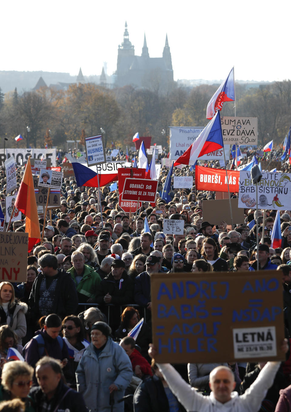 People take part in a large anti-government protest in Prague, Czech Republic, Saturday, Nov. 16, 2019. Czechs are rallying in big numbers to use the 30th anniversary of the pro-democratic Velvet Revolution and urge Prime Minister Andrej Babis to resign as peaceful protesters from all corners of the Czech Republic are attending the second massive protest opposing Babis at Letna park, a site of massive gatherings that significantly contributed to the fall of communism in 1989. (AP Photo/Petr David Josek)