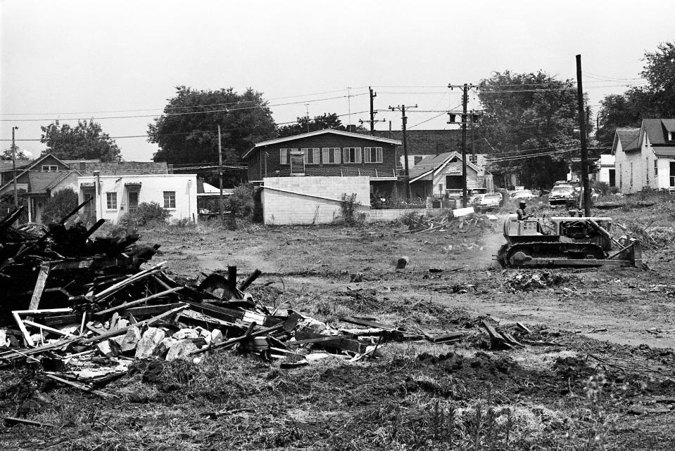 A bulldozer is busy clearing the land of what once were homes in North Nashville on July 16, 1968 for the path of Interstate 40 to come through.