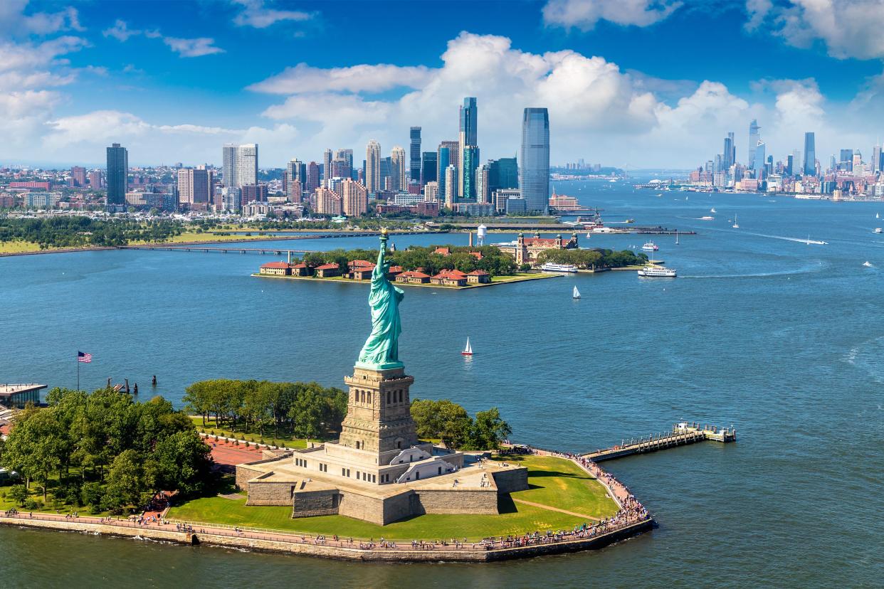 Panoramic aerial view Statue of Liberty and Jersey City and Manhattan cityscape in New York City, NY, USA