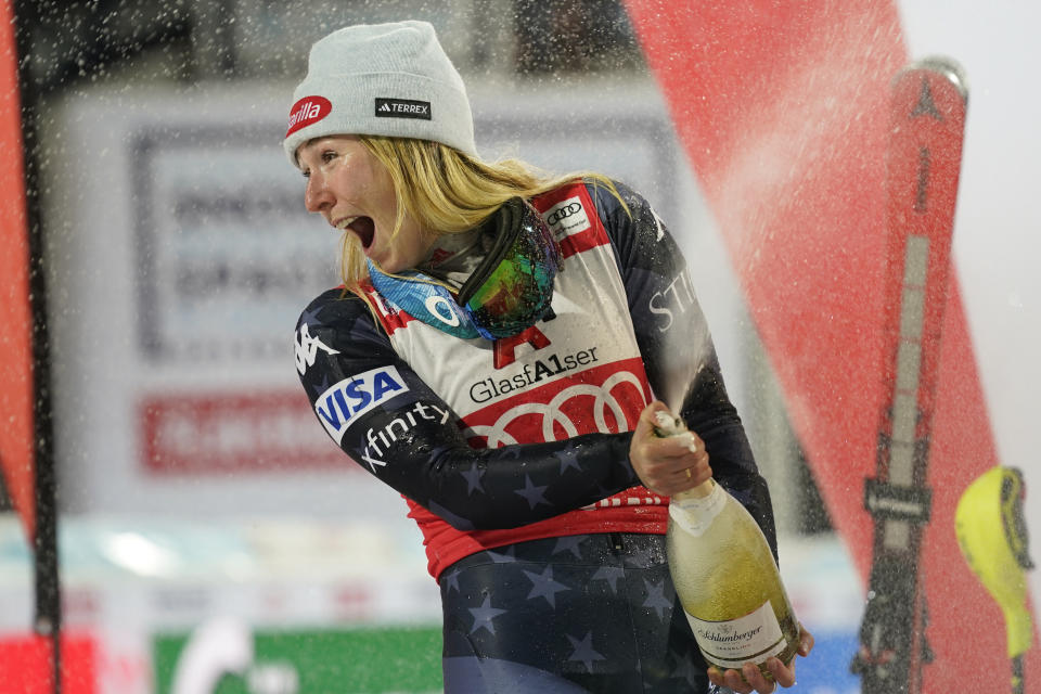 United States' Mikaela Shiffrin celebrates on podium after finishing second in a alpine ski, women's World Cup slalom in Flachau, Austria, Tuesday, Jan.10, 2023. American skier Mikaela Shiffrin finished second to Olympic champion Petra Vlhova in a night slalom race Tuesday, meaning she will have to wait for another chance to break the record for most wins on the women’s World Cup circuit. (AP Photo/Giovanni Auletta)