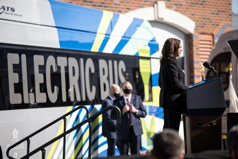 Vice President Kamala Harris on stage during a speech in Charlotte on Dec. 2, 2021. Behind her is one of the city’s new electric buses. 