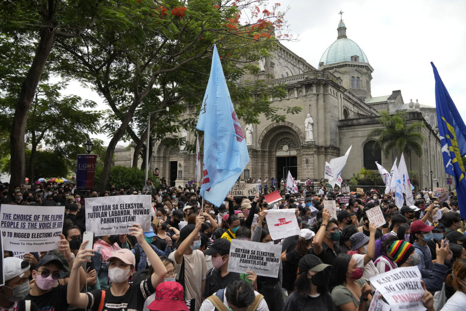 Students and activists hold slogans during a rally in front of the office of the Commission on Elections as they question the results of the presidential elections in Manila, Philippines on Tuesday May 10, 2022. The namesake son of late Philippine dictator Ferdinand Marcos appeared to have been elected Philippine president by a landslide in an astonishing reversal of the 1986 "People Power" pro-democracy revolt that booted his father into global infamy. (AP Photo/Aaron Favila)