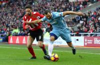 <p>Fabio Borini of Sunderland has his shirt tugged by Erik Pieters of Stoke City</p>