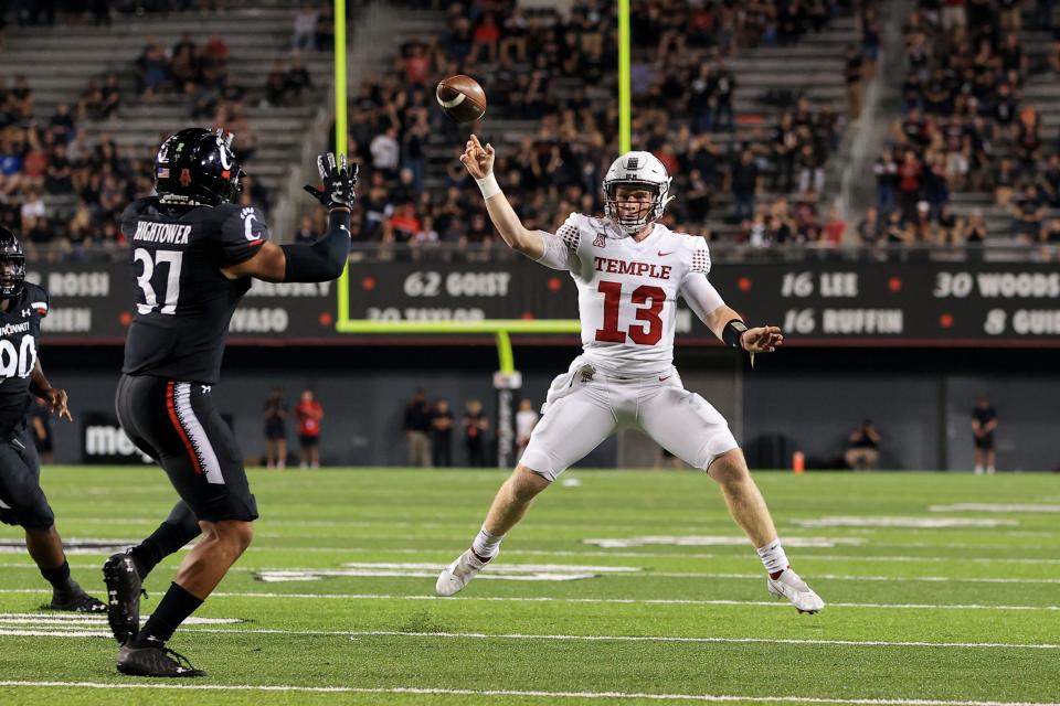 Cincinnati linebacker Devin Hightower (37) defends as Temple quarterback Justin Lynch (13) throws a pass during an NCAA college football game, Friday, Oct. 8, 2021, in Cincinnati. Cincinnati won 52-3.