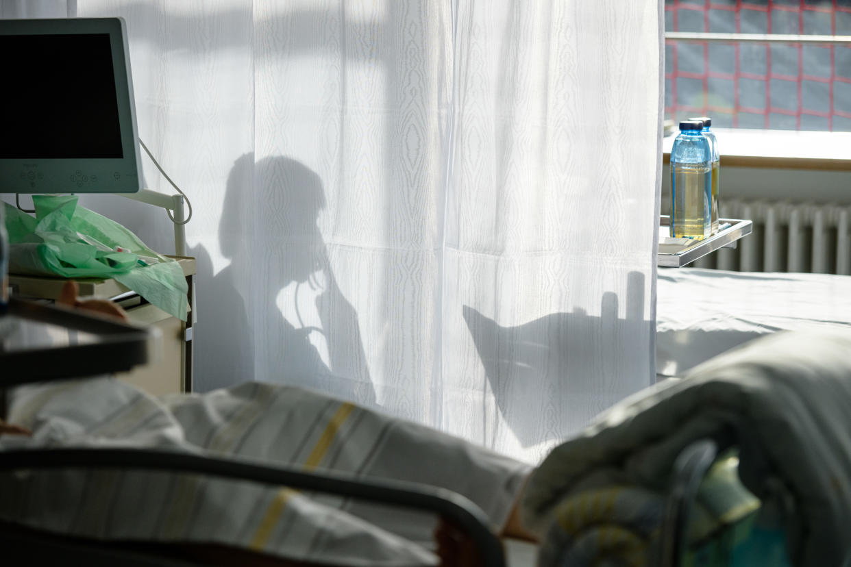 A silhouette of a patient being treated in a hospital.