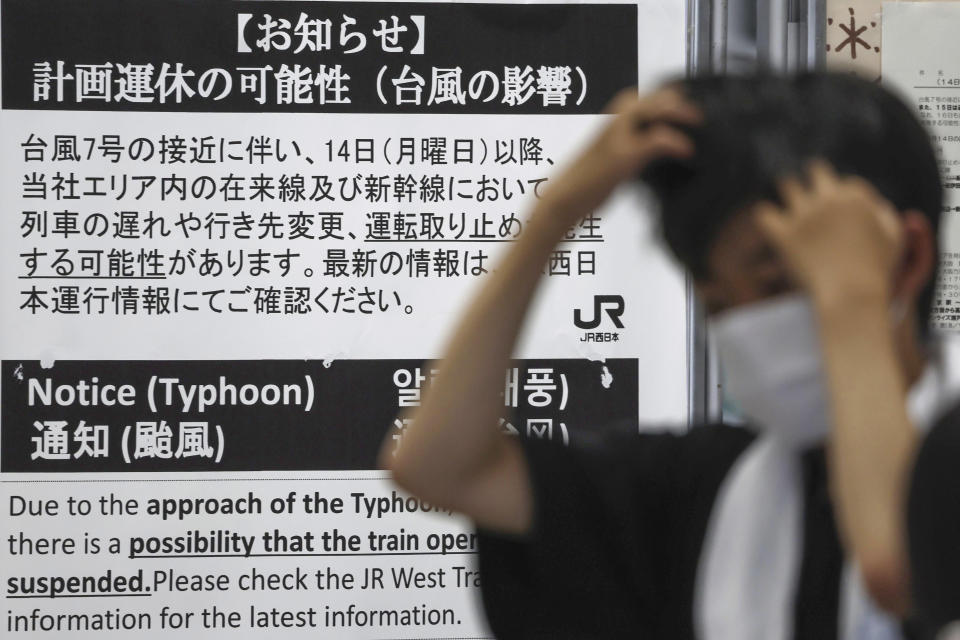 A sign notices the possibility of suspension of train services due to approaching Typhoon Lan at a train station in Shirahama, Wakayama prefecture, western Japan Monday, Aug. 14, 2023. The powerful typhoon was approaching Japan's main archipelago of Honshu on Monday threatening to hit large areas of western and central Japan with heavy rain and high winds, as many people were traveling for a Buddhist holiday week. (Kyodo News via AP)