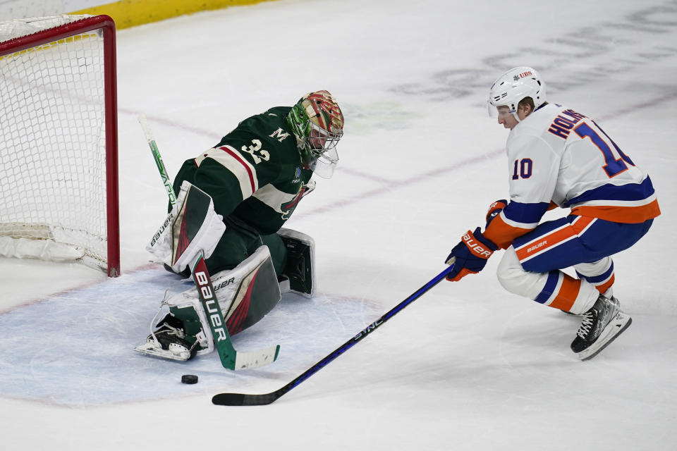 Minnesota Wild goaltender Filip Gustavsson stops a shot by New York Islanders right wing Simon Holmstrom a shootout of an NHL hockey game Tuesday, Feb. 28, 2023, in St. Paul, Minn. (AP Photo/Abbie Parr)