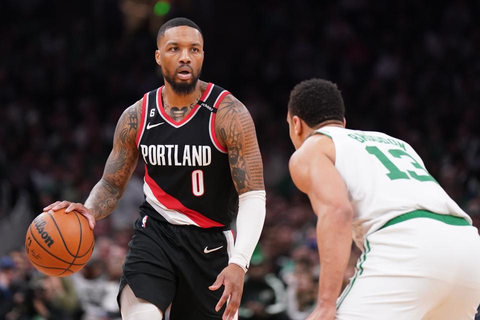 In his final season for the Portland Trail Blazers, Damian Lillard dribbles the ball against Boston Celtics forward Jayson Tatum in a March game.