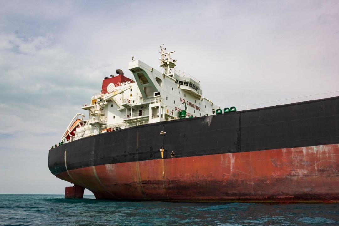 Anchored oil tanker loaded with oil barrels in the Persian Gulf. Iran exports oil to South Asia and Eastern countries.