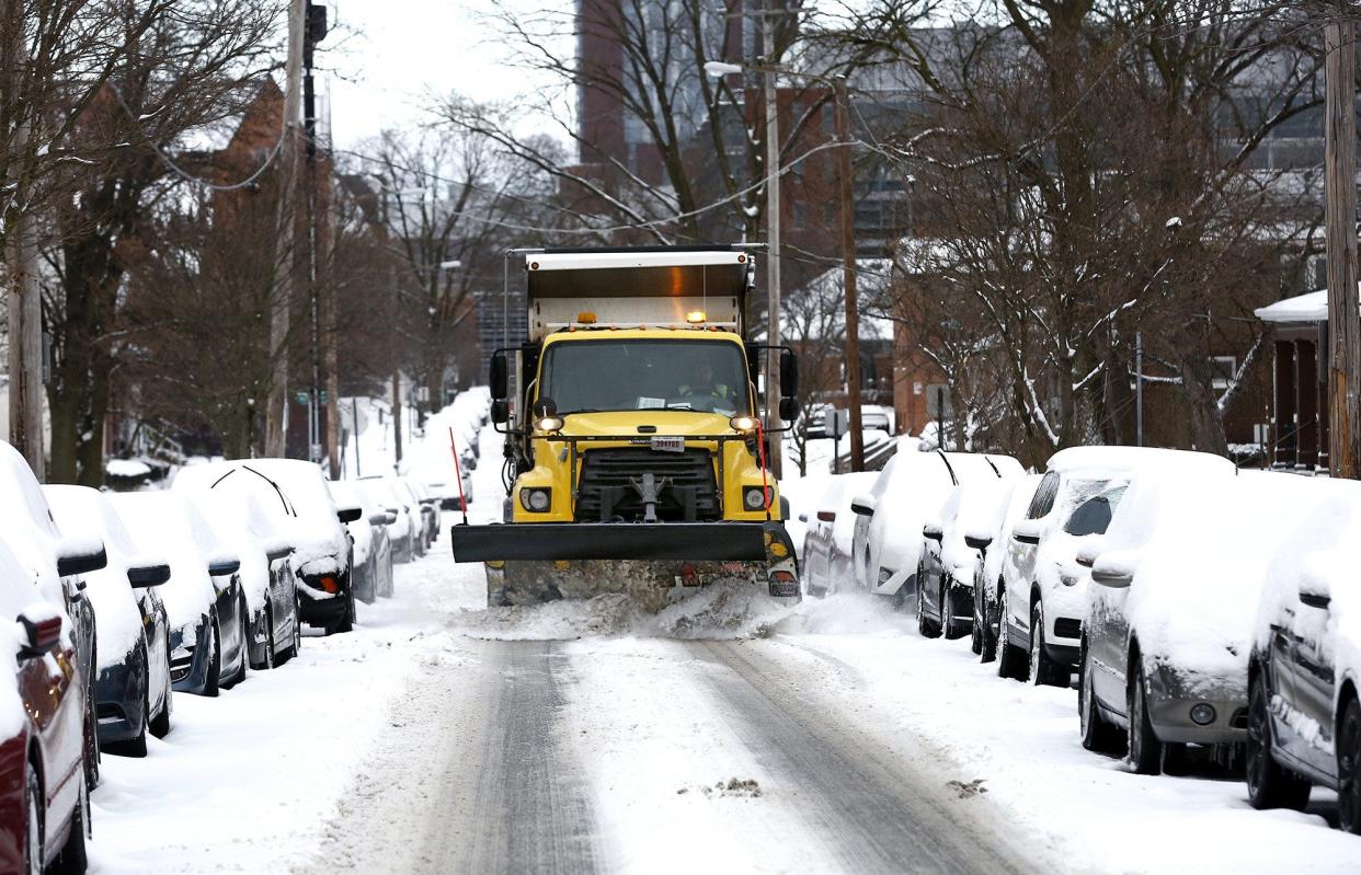 A snow plow cleans a section of West 10th Avenue in Columbus, a side street near Ohio State University on Feb. 2, 2021.