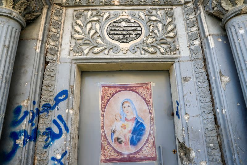 A picture of the Virgin Mary is seen on the door of a church in the old city of Mosul