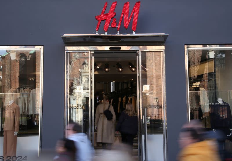 People walk past a branch of fashion retailer H&M in Copenhagen