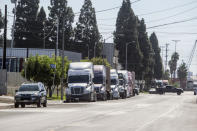 Parked cargo container trucks are seen in a street, Wednesday, Oct. 20, 2021 in Wilmington, Calif. California Gov. Gavin Newsom on Wednesday issued an order that aims to ease bottlenecks at the ports of Los Angeles and Long Beach that have spilled over into neighborhoods where cargo trucks are clogging residential streets. (AP Photo/Ringo H.W. Chiu)