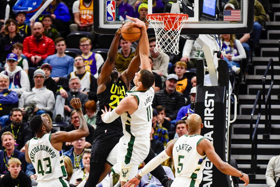 Bucks center Brook Lopez denies Jazz center/forward Udoka Azubuike next to the basket during the second half for one of his seven blocks Friday night.