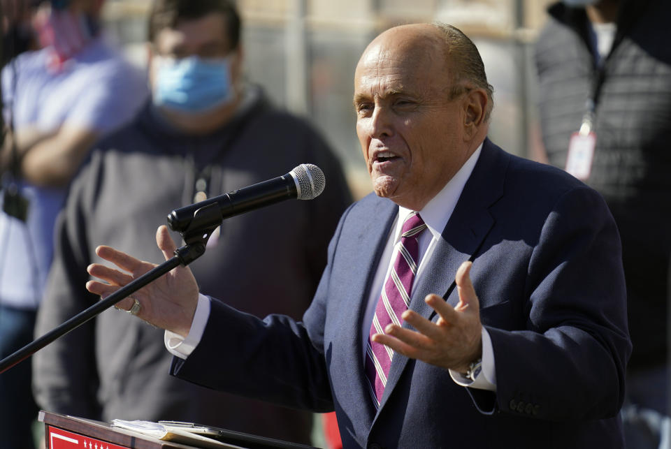 FILE - In this Saturday Nov. 7, 2020, file photo, former New York Mayor Rudy Giuliani, a lawyer for President Donald Trump, speaks during a news conference on legal challenges to vote counting in Pennsylvania, in Philadelphia. Giuliani and his lawyers will get to designate which materials seized from him will be reviewed by a court-appointed expert reviewer to determine what should never be seen by federal prosecutors. As part of the investigation, federal agents seized 18 electronic devices from Giuliani's residence and his firm, Giuliani Partners LLC. (AP Photo/John Minchillo, File)