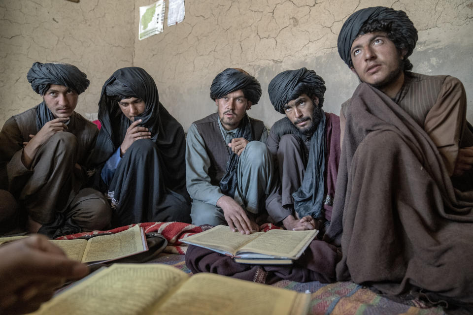 Young men sit together in a religious school in Afghanistan, on Sunday, Feb. 26, 2023. (AP Photo/Ebrahim Noroozi)