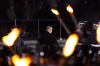 Chancellor Angela Merkel attends in a Grand Tattoo ceremony to mark the farewell of her chancellorship in Berlin, Germany, Thursday, Dec. 2, 2021. With one week left before Merkel steps aside, she is being treated to a traditional send off involving the military ceremony with a brass band playing her choice of music. (AP Photo/Markus Schreiber)