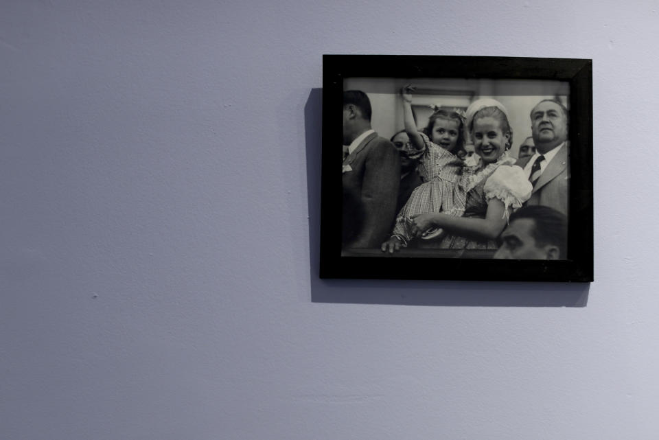 A photo of Evita Perón, holding a child in her arms, hangs from a wall of the Evita Museum as part of the "Childhood and Peronism, the toys of the Eva Perón Foundation" exhibit, in Buenos Aires, Argentina, Wednesday, April 17, 2019. The Evita Museum is visited by dozens of tourists on a daily basis. (AP Photo/Natacha Pisarenko)